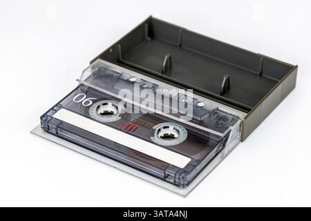 Vintage Audio Cassette: A nostalgic view of an audio cassette in its protective case. Captured in precise detail, ready for your creative needs. Stock Photo