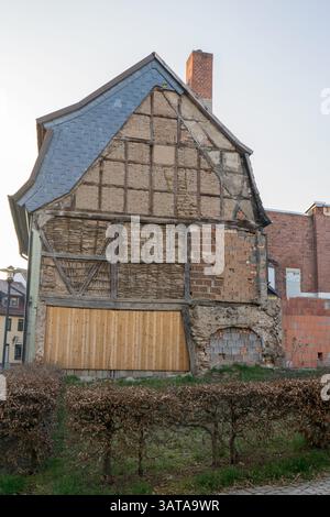Detail of an old timber-framed house wall with bricks, laths, and clay Stock Photo