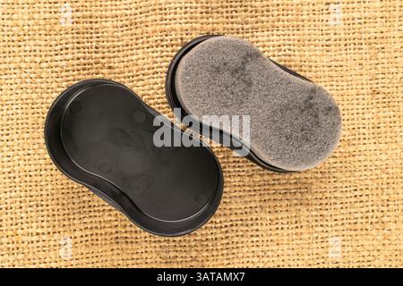 Shoe cleaning sponge on jute cloth, close-up, top view. Stock Photo