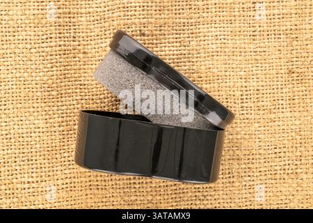Shoe cleaning sponge on jute cloth, close-up, top view. Stock Photo