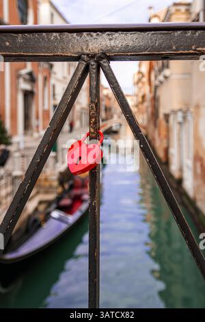 a red heart-shaped padlock left on a bridge in venice Stock Photo