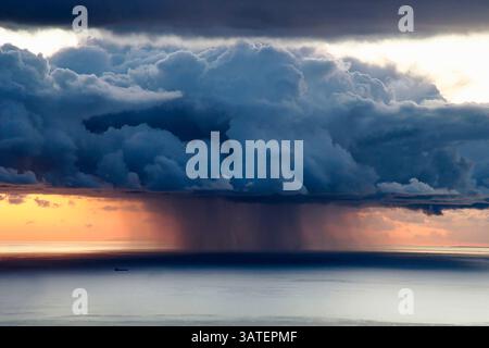 Curtain of rain, also known as column of precipitation, appears under storm clouds such as cumulonimbus or shower clouds such as cumulus congestus. Fr Stock Photo