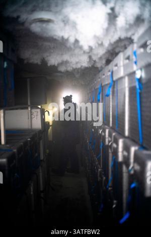 A scientist comes to retrieve an ice core stored in an underground cellar. These ice cores contain the climate archives of the past. These cores allow Stock Photo