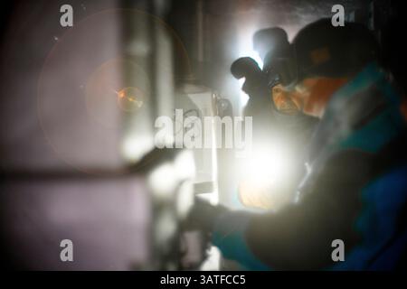 Scientists come to recover an ice core stored in an underground cellar. These ice cores contain the climate archives of the past. The cores in questio Stock Photo