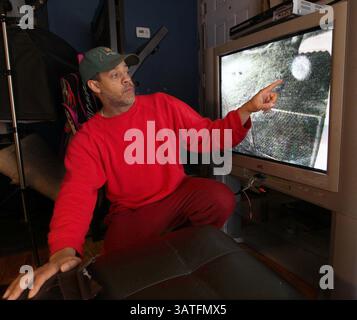 Oct. 18, 2013 - Akron, OH, USA - Michael Bruner shows the video of an orb he captured with his surveillance camera mounted outside his home on Selzer Street in Akron, Ohio, October 18, 2013. (Credit Image: © Phil Masturzo/MCT/ZUMAPRESS.com) Stock Photo