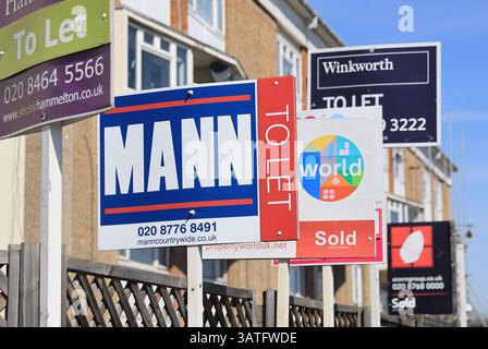 For sale and for rent signs outside houses in SE London, UK Stock Photo