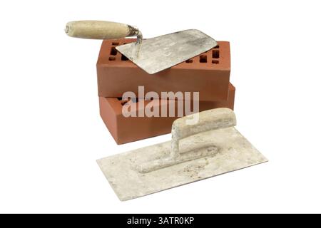 Two trowels with red bricks - isolated on white background Two old trowels and red bricks - isolated on white background Stock Photo