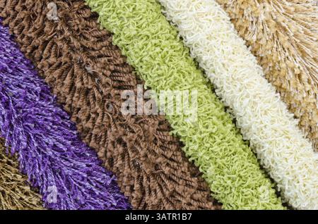 Different colourful artificial shaggy carpet samples, closeup Stock Photo