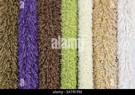 Different colourful artificial shaggy carpet samples, closeup Stock Photo