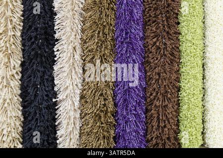 Different colourful artificial shaggy carpet samples, closeup Stock Photo