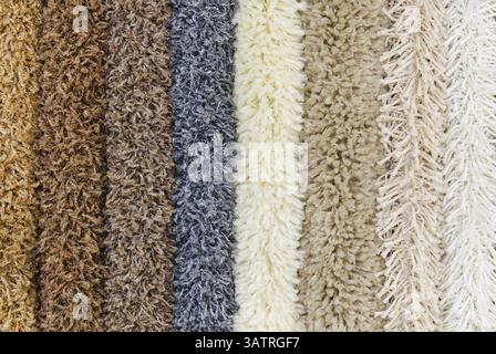 Different colourful artificial shaggy carpet samples, closeup Stock Photo