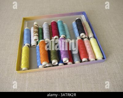 Sewing thread in different colours in a box Stock Photo