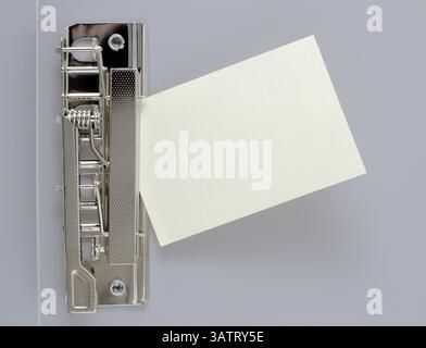 A small blank sheet of note paper in a clip file Stock Photo