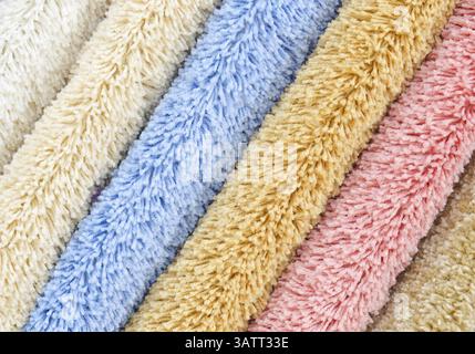 Different colourful artificial shaggy carpet samples, closeup Stock Photo