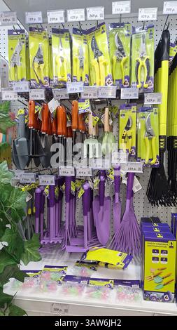 Moscow, Russia - February 27, 2025:Assorted garden tools display in store on pegboard shelves Stock Photo