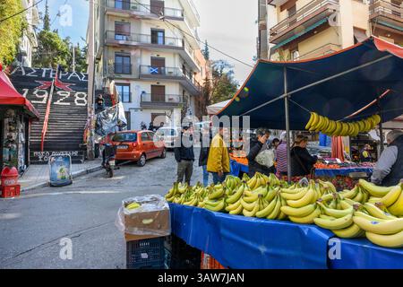 Stalls at Exarcheia's Saturday fruit and vegetable market, with the steps to Lofos srefi, Strefi Hill, in the background.  Exarcheia, Athens, Greece. Stock Photo