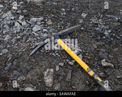 pickaxe on stones. Construction tool on a job site Stock Photo