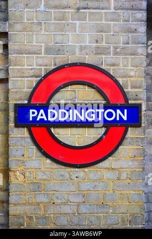 London, UK - April 3, 2025; London Underground red and blue roundel at Paddington on brick wall Stock Photo