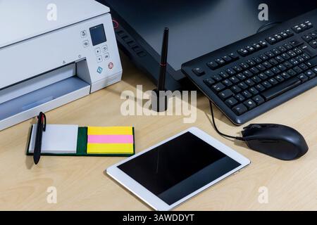 Keyboard, tablet and graphics tablet on desk Stock Photo - Alamy