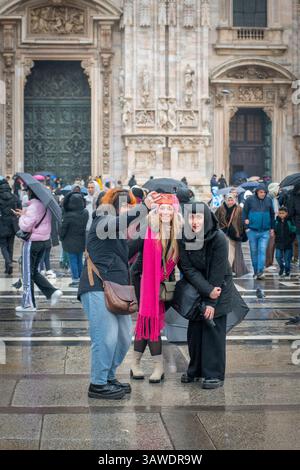 Group of three women outside Milan Cathedral taking a selfie. Piazza del Duomo, Milan, Italy. Stock Photo