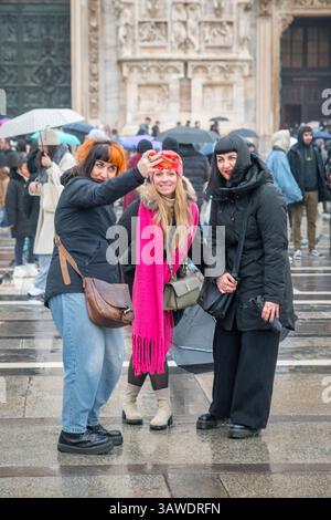 Group of three women outside Milan Cathedral taking a selfie. Piazza del Duomo, Milan, Italy. Stock Photo