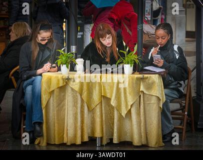 Three women sitting at a table relaxing al fresco. Friends enjoying a citybreak in Milan. Piazza del Duomo, Milan, Italy. Stock Photo