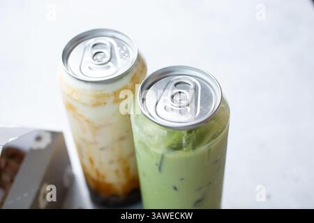 A view of two novelty boba milk tea aluminum can tops on plastic bottles. Stock Photo
