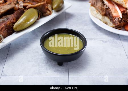 A view of a condiment cup filled with salsa verde. Stock Photo