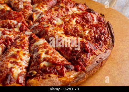 A view of a deep dish style pepperoni pizza. Stock Photo