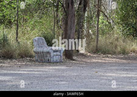 Sofa chair abandoned under a tree in the Australian bush Stock Photo