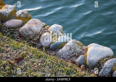 Waterside Rocks line of gray rocks along the waterside Stock Photo - Alamy