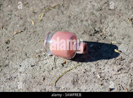 pink nail polish left on ground Stock Photo