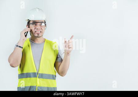Handsome engineer calling on phone isolated. Constructor engineer talking phone isolated Stock Photo
