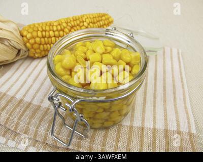 Cooked corn kernels in a jar Stock Photo - Alamy