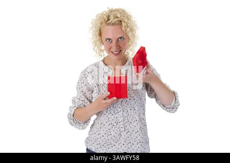 Young blonde woman holding a red gift in her hand Young blonde woman holding a red gift in her hand Stock Photo