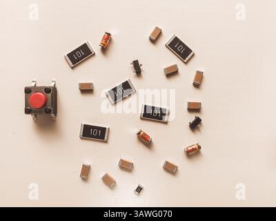 Surface-mount resistors, diodes and push button on white background Stock Photo