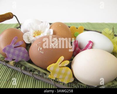 Naturally colourful eggs in the Easter basket Stock Photo