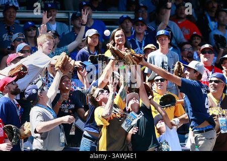 Fans reach for a batting practice ball prior to Game 3 of baseball's ...