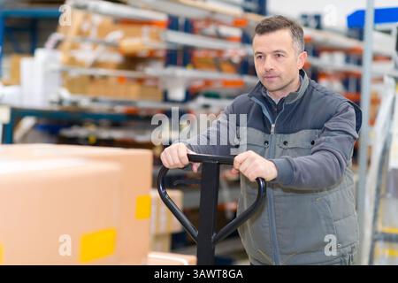 porter carrying boxes in a warehouse Stock Photo