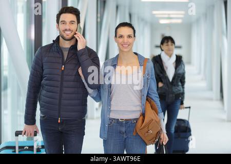 traveler using the smart mobile phone at the arrivals Stock Photo