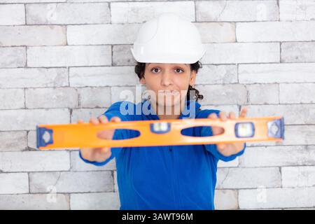 smiling female worker using a spirit level Stock Photo