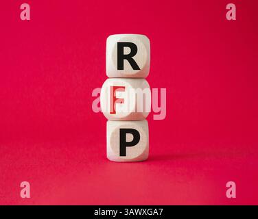 RFP - Request for Proposal. Wooden cubes with word RFP. Beautiful red background. Business and Request for Proposal concept. Copy space. Stock Photo