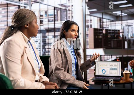 Women leaders strategizing in a corporate office focused on growth, innovation and gender equality. Empowered entrepreneurs team uniting forces to achieve business success, productivity. Stock Photo