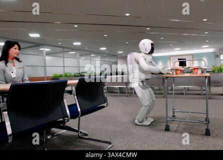 Honda Motor Co.'s humanoid robot ASIMO stands by the reception of an office during a media demonstration of Honda's new intelligence technologies, whi Stock Photo
