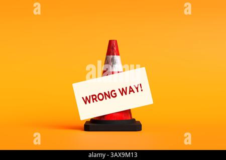 Red traffic cone displaying a wrong way sign against an orange background, illustrating the concept of heading in the wrong direction. 3D render. Stock Photo