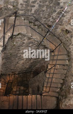 Trsat castle, Rijeka, Croatia. Stone structure. Looking down a spiral staircase. The winding spiral staircase. Stock Photo