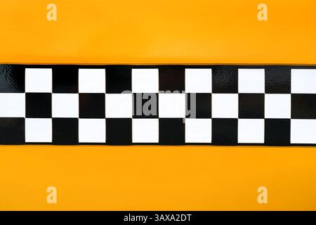 Black and white checkered pattern on yellow background, inspired by New York yellow cab taxi vehicle design. Copy space included. Stock Photo