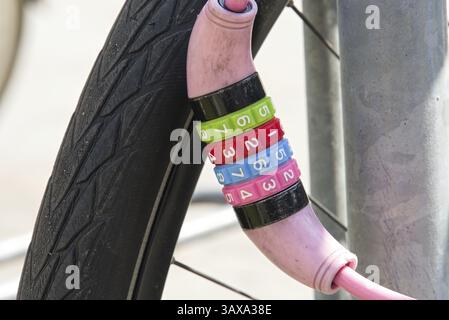 Brightly coloured bike lock with combination lock - close-up combination lock Stock Photo