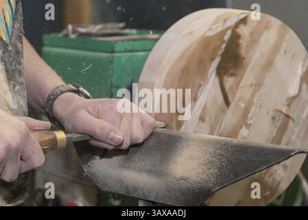 Carpenter working with chisels on a lathe - close-up of carpenter Stock Photo