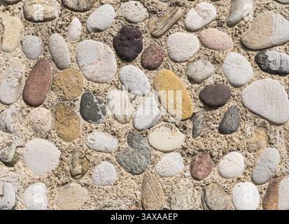 Coloured pebbles - background with a wall of coloured pebbles - mosaic, pattern Stock Photo
